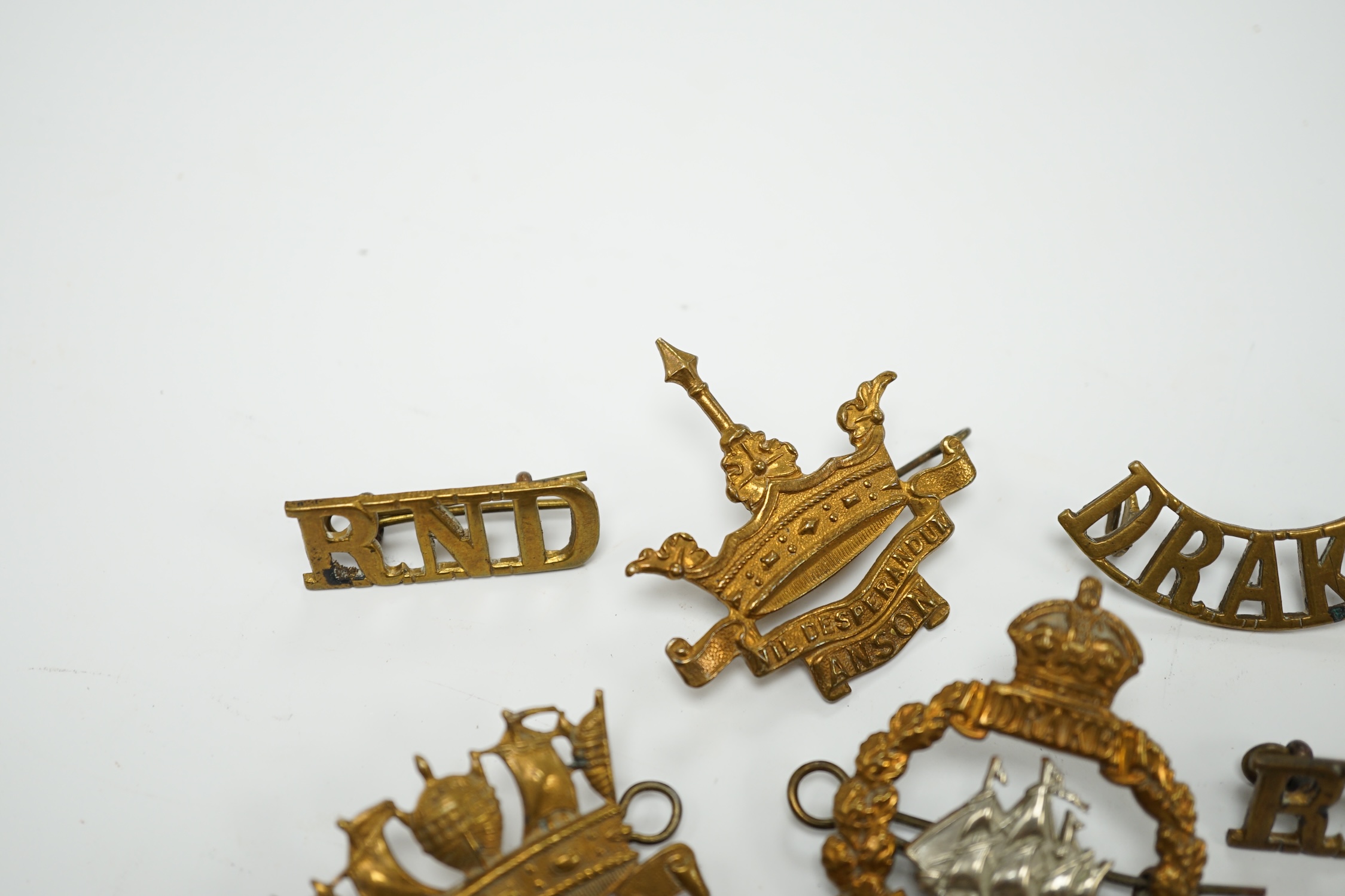 Five Royal Navy First World War brass cap badges; the Nelson, Hawke, Anson and Howe Battalions, together with three shoulder titles. Condition - fair, some possible restrikes.